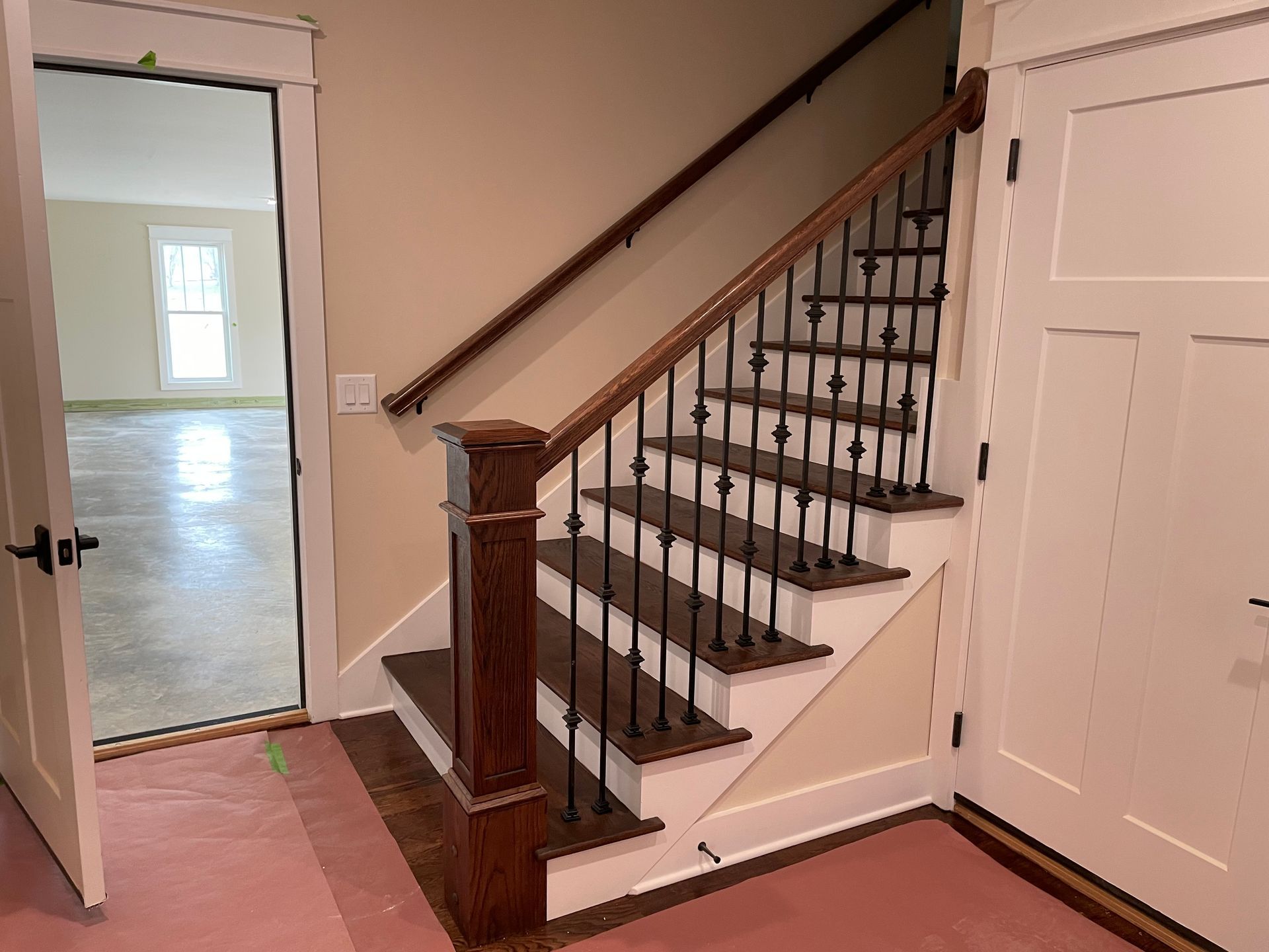 A staircase with a wooden railing and white steps