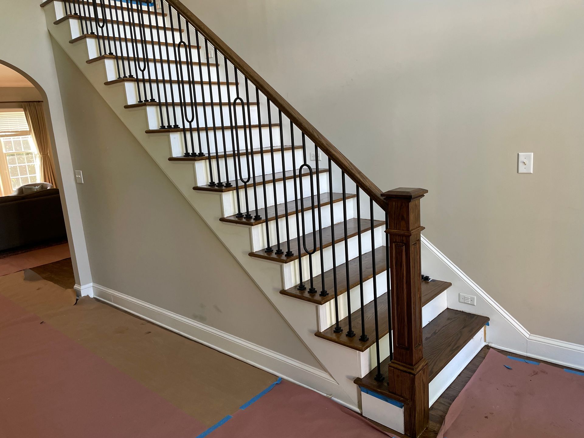 A staircase in a house with a wooden railing and steps.