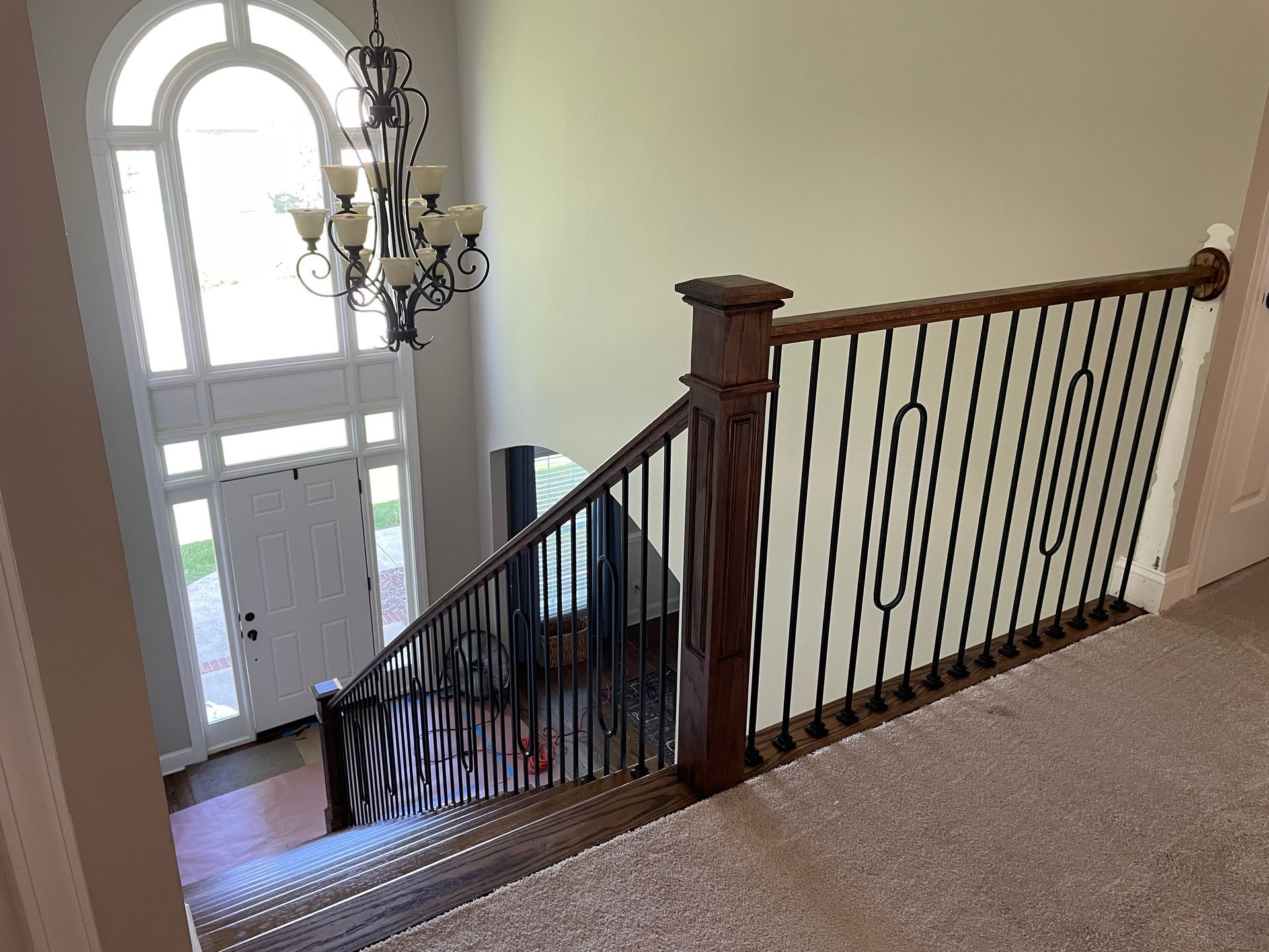 A view of a staircase from the second floor of a house.