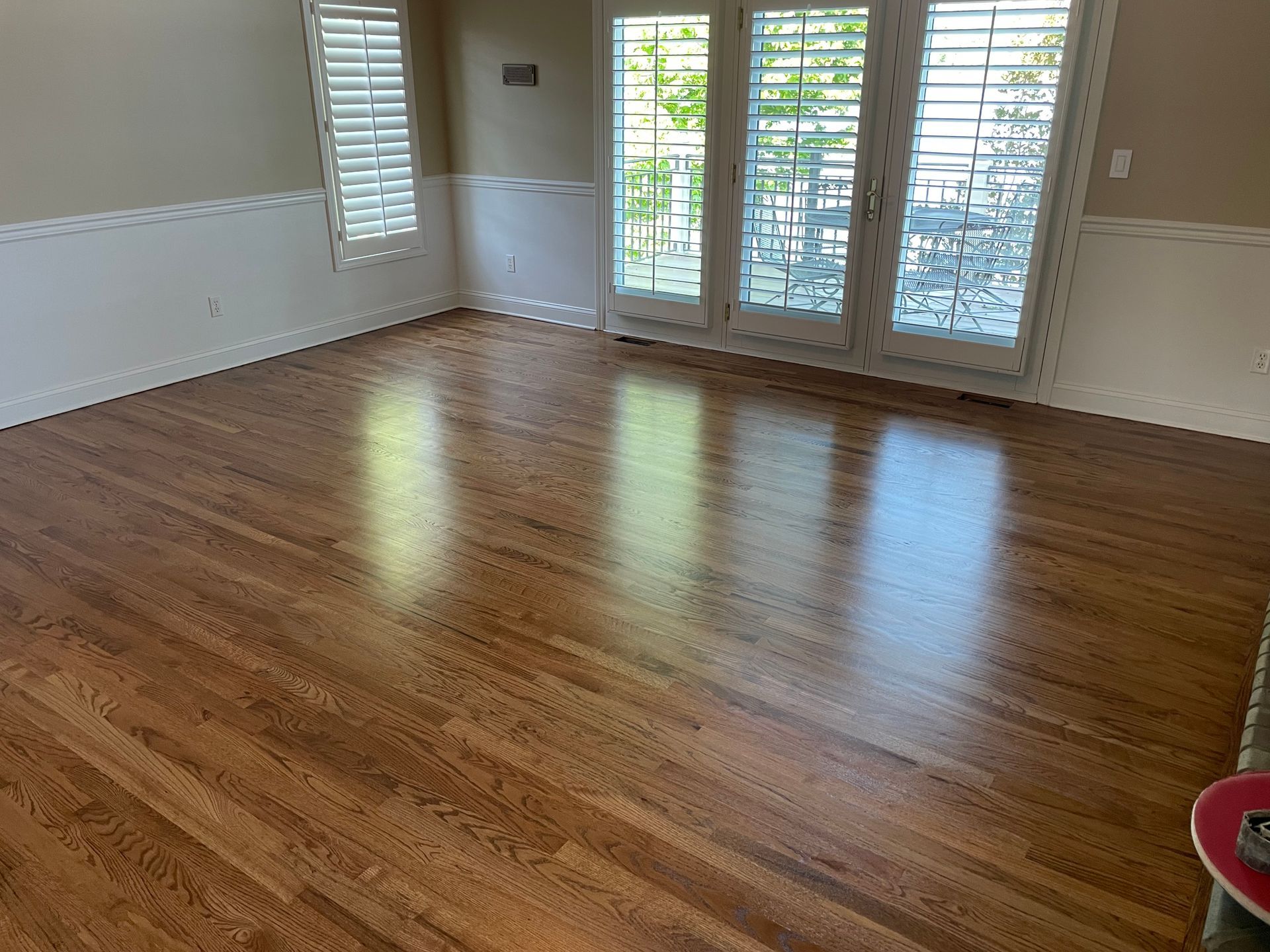 A living room with hardwood floors and sliding glass doors.