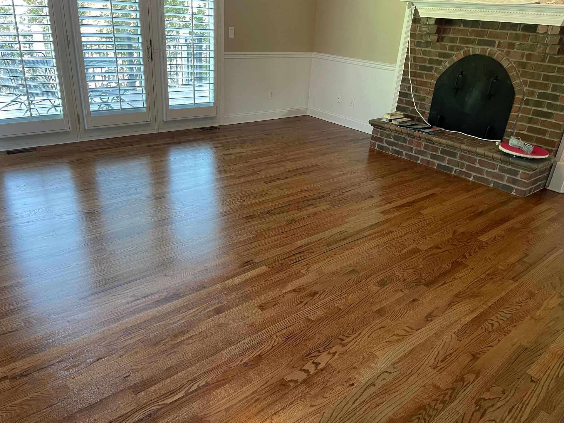 A living room with hardwood floors and a fireplace.