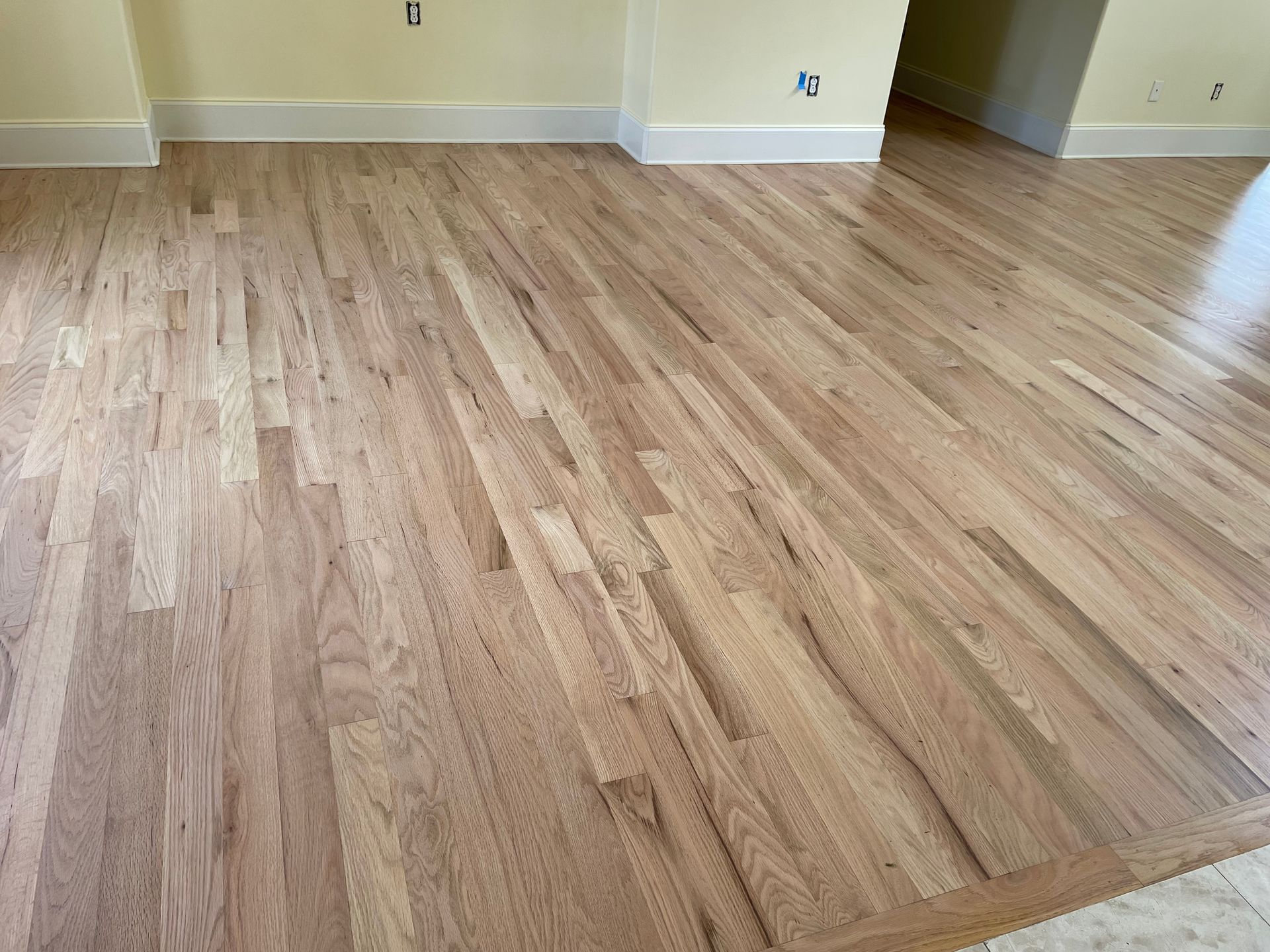 A room with a wooden floor and yellow walls