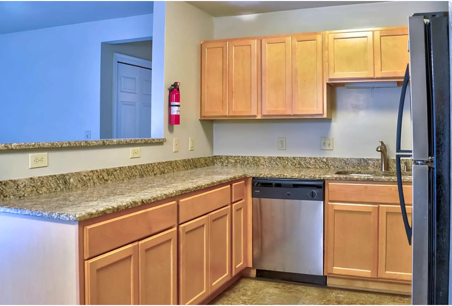 A kitchen with stainless steel appliances and wooden cabinets