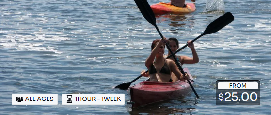 A woman is paddling a red kayak on a lake.