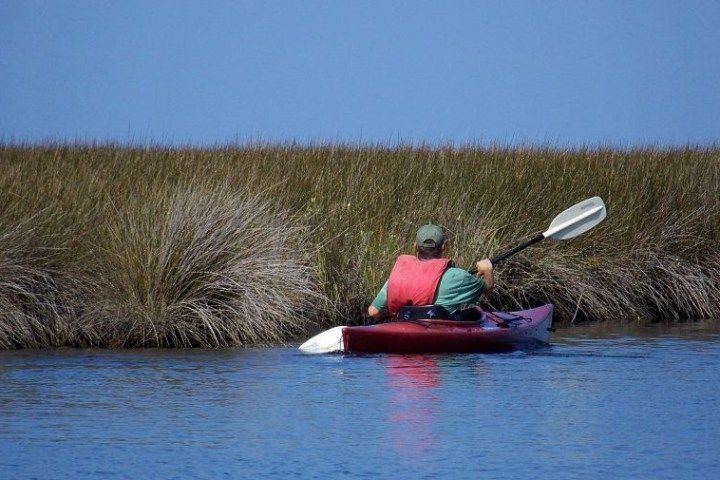 A group of people are riding a red jet ski.