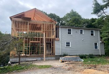 A large house is being built in the middle of a forest.