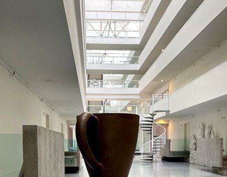 A large coffee cup is in the middle of a building