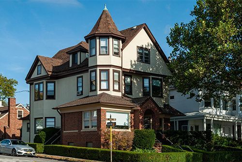 A large house with a tower on top of it