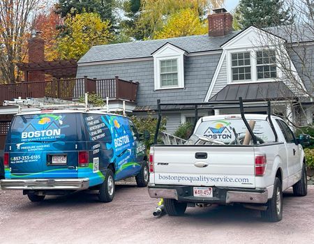 Two trucks are parked in front of a house.