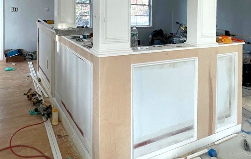 A kitchen island is being built in a house.