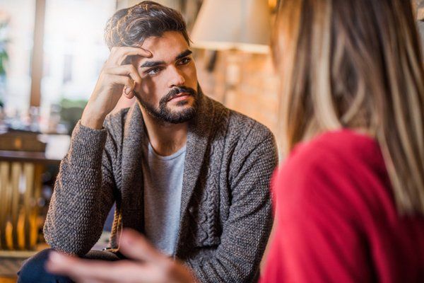 Young man listening to his girlfriend about her problems.