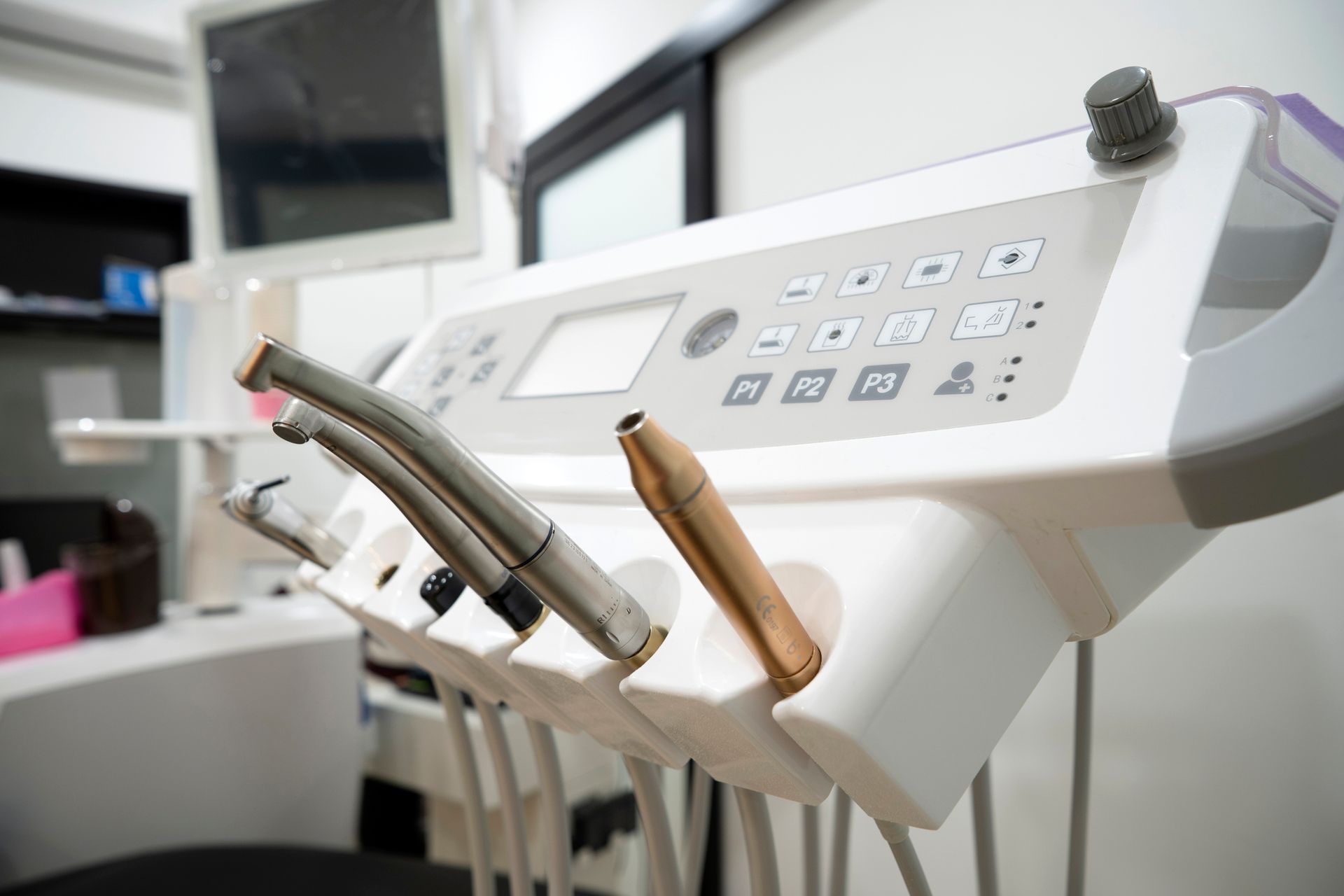 Dental tools, including drills, in a dental office setting.