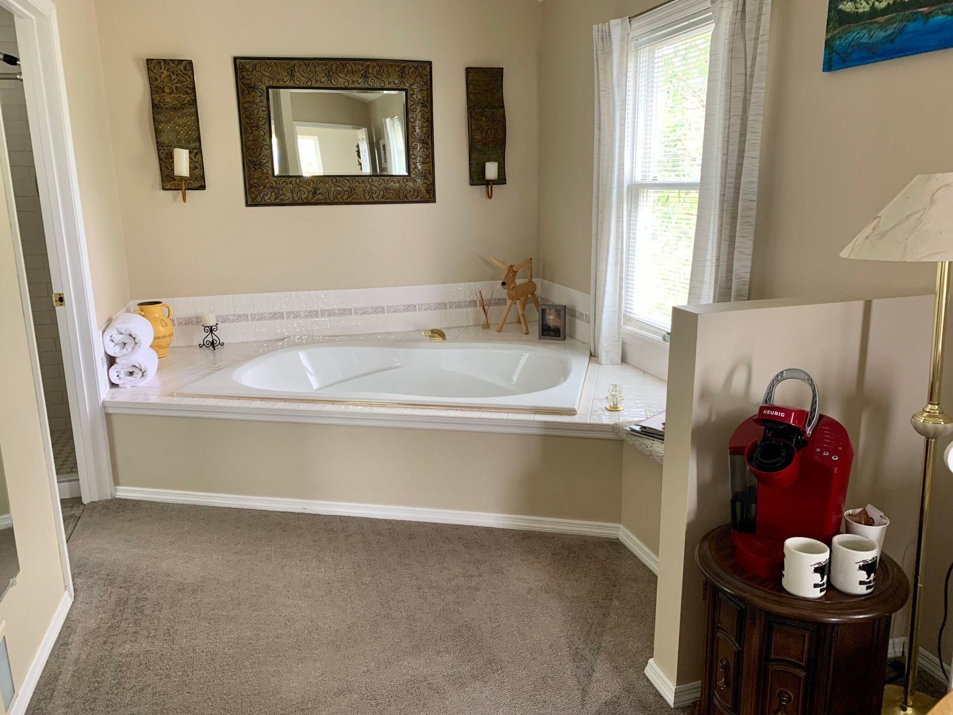 A bathroom with a jacuzzi tub and a coffee maker.