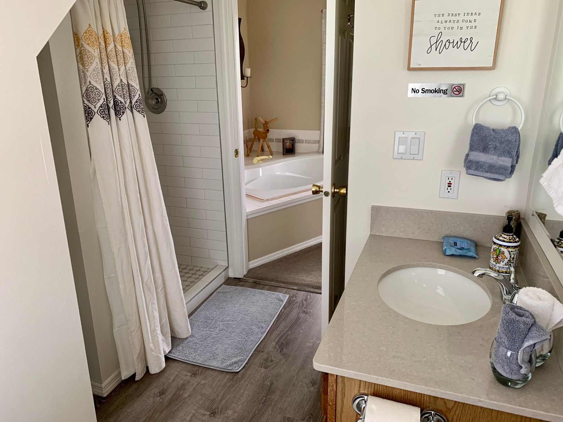 A bathroom with a sink , shower , and bathtub.