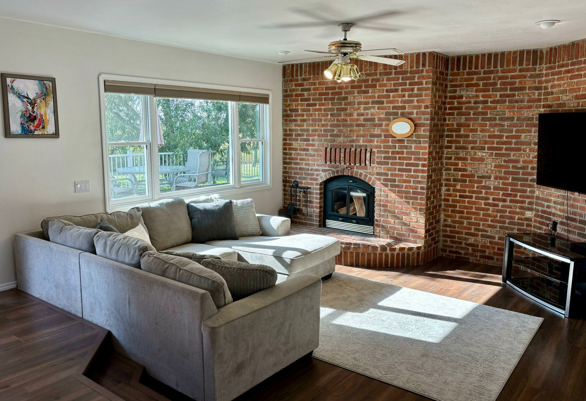 A living room with a couch , fireplace and television.