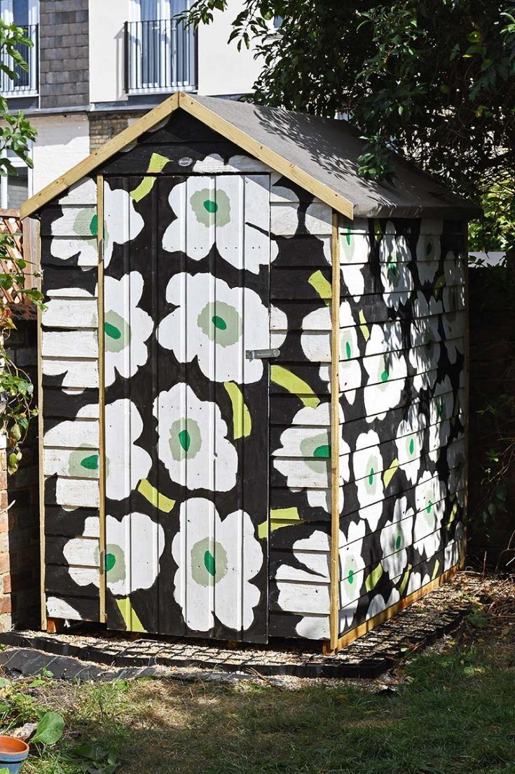 Flower painted shed in white and black in Newport, Wales. Expertly painted by Orchid Decor. 