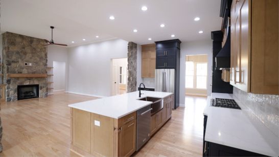 A kitchen with a large island and stainless steel appliances