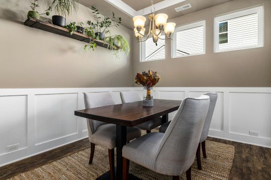 A dining table near a bathtub, washbasin, and patio.