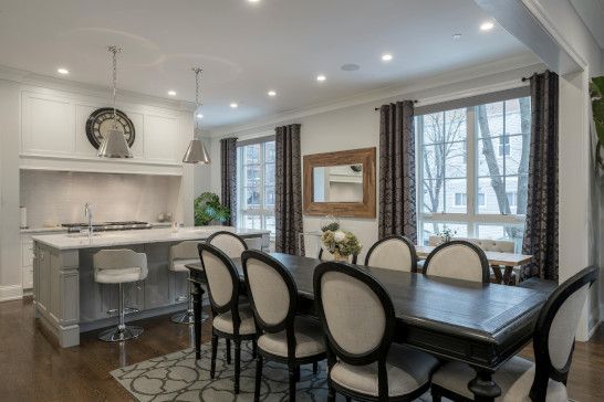 A dining table with a china cabinet and folding chairs in a restaurant.