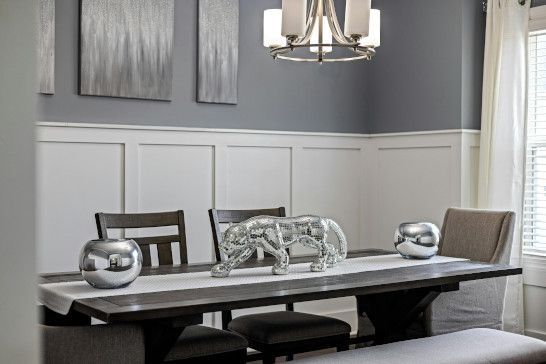 A dining table with a plate rack, desk, and china cabinet.