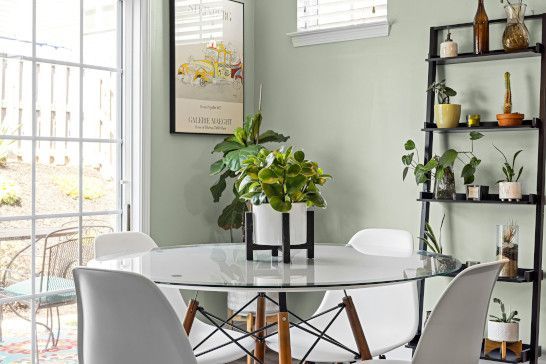 A dining table in a restaurant with a pot and desk nearby.