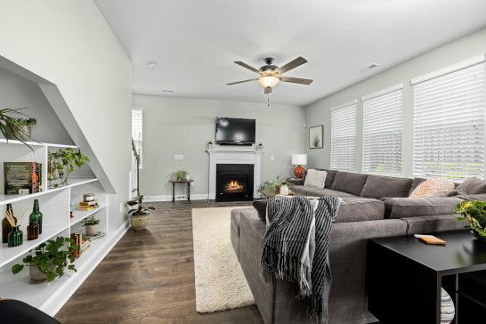 A dining table with a studio couch, home theater, and sliding door.