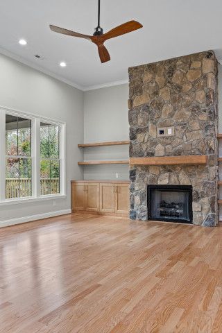 A home theater with an entertainment center, sliding door, and bannister.