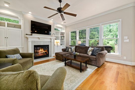 A home theater with a window shade, patio, and sliding door.