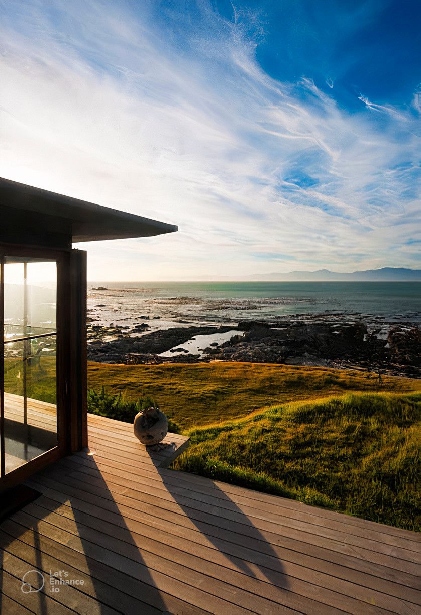 A house with a view of the ocean from the deck.