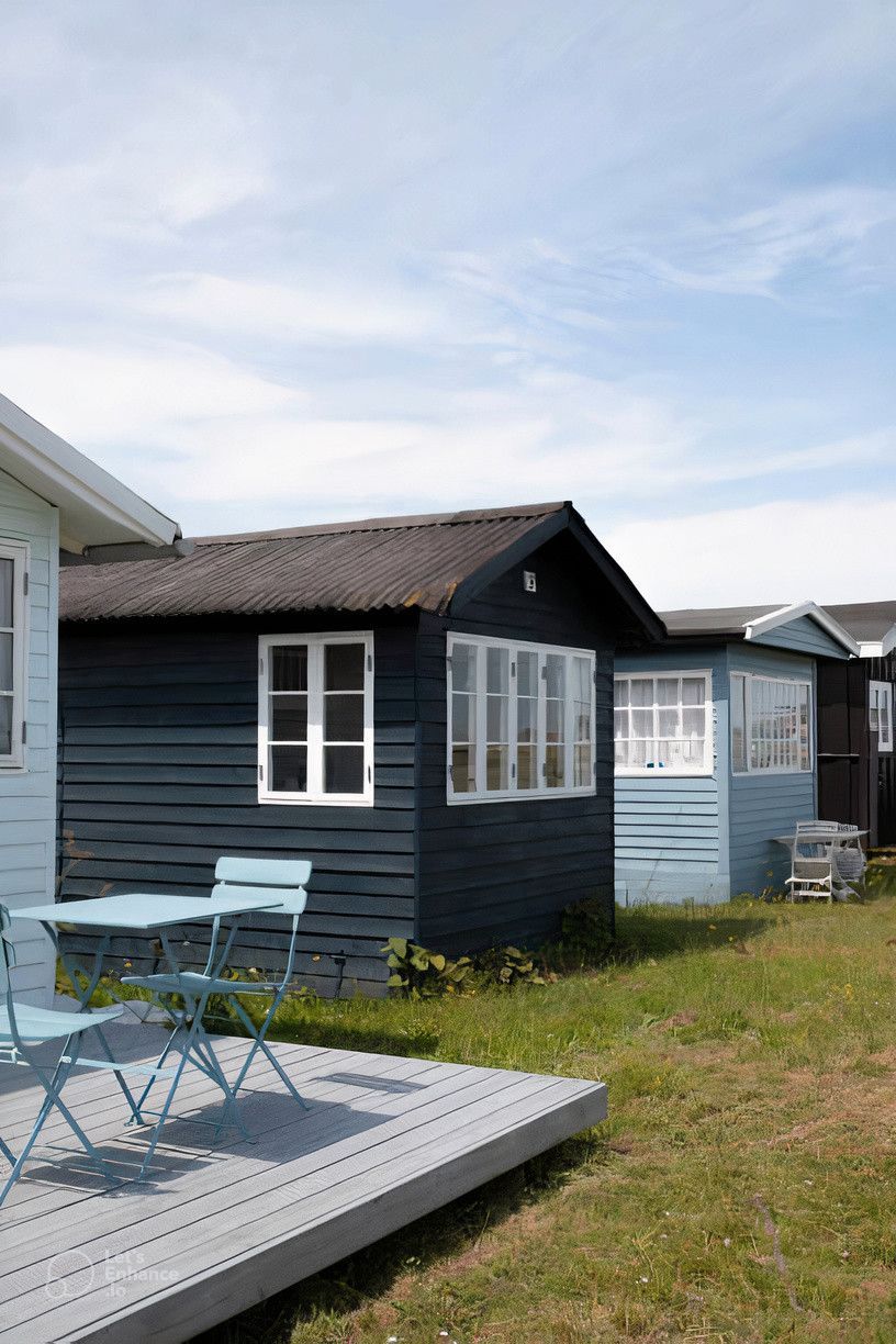 A small house with a table and chairs in front of it.