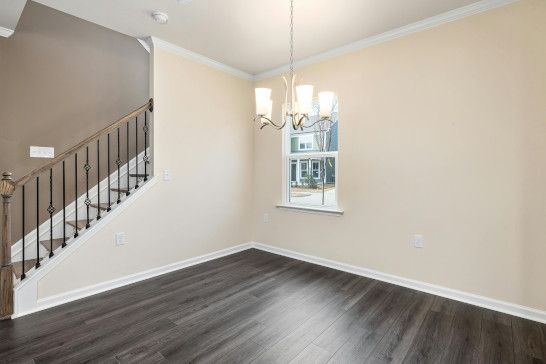 A medicine chest near a bannister and dishwasher in a modern room.