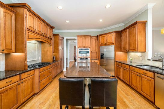 A microwave, washbasin, and home theater setup in a compact space.