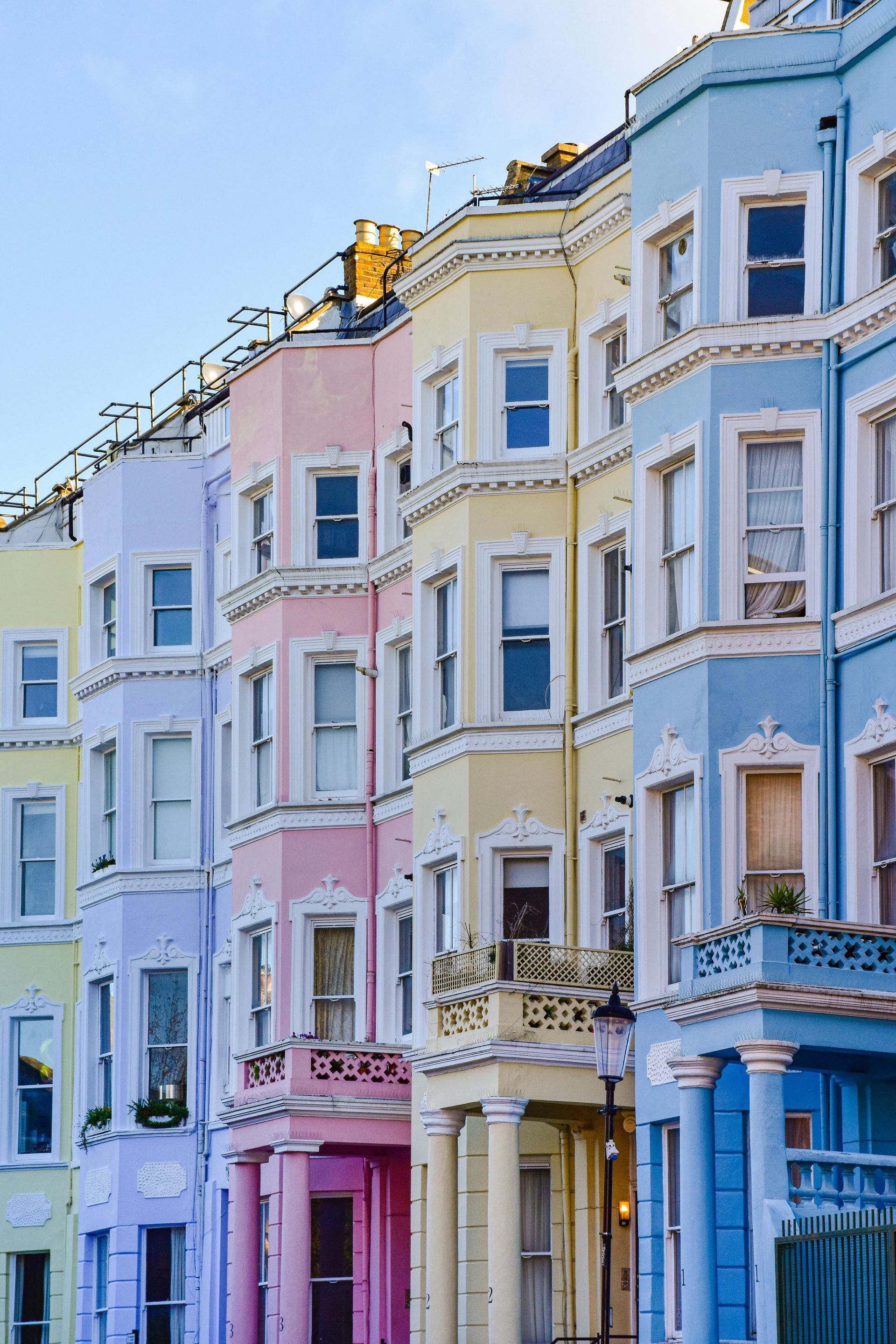 Colourful UK flats in pastel purple, pink, yellow and blue. Exterior painting of apartments by Orchid decor in Newport, Wales.