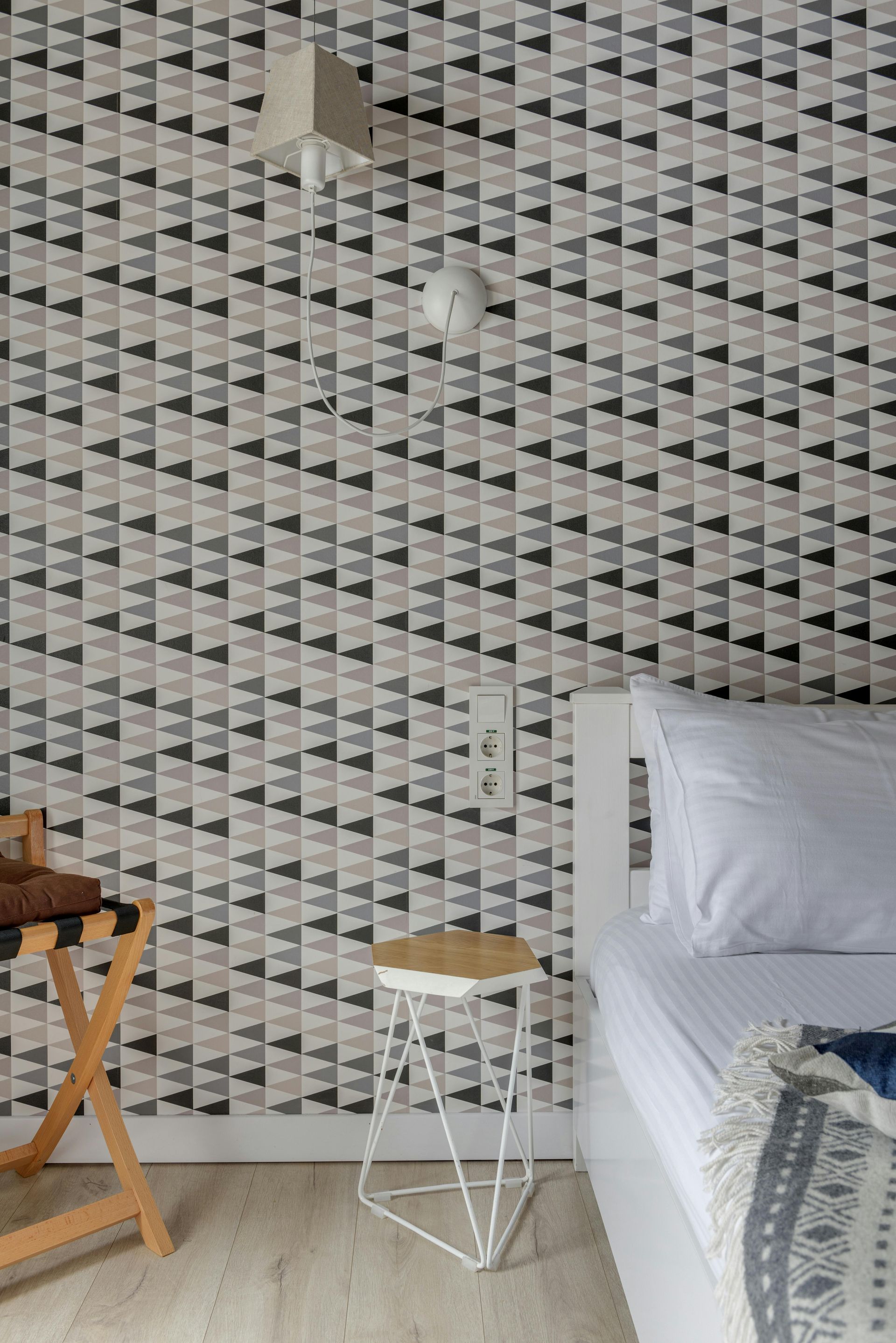 Bedroom with geometric triangular wallpaper