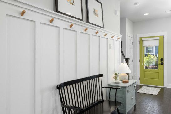 A rocking chair near a sliding door, plate rack, and dining table.
