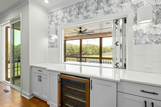 A sliding door with a medicine chest, plate rack, and microwave.