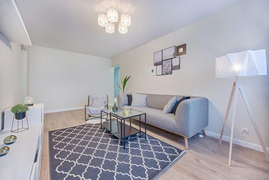 A studio couch near a crib, bathtub, mosquito net, and patio.