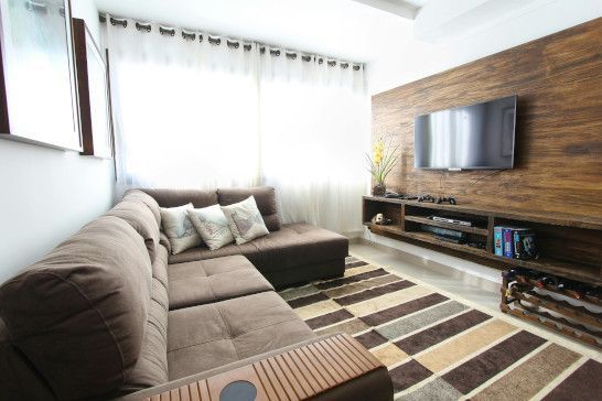 A studio couch with a four-poster bed, window shade, and sliding door.