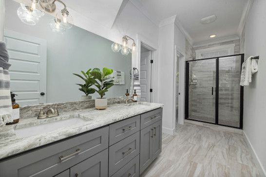 A washbasin, bathtub, and medicine chest in a bathroom.