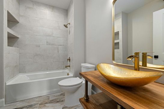 A washbasin with a bathtub, tub, and soap dispenser.