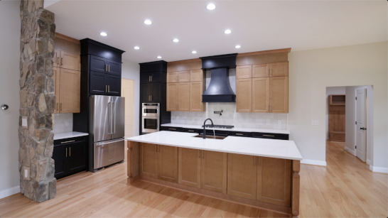 A washbasin, tub, and home theater with an entertainment center.