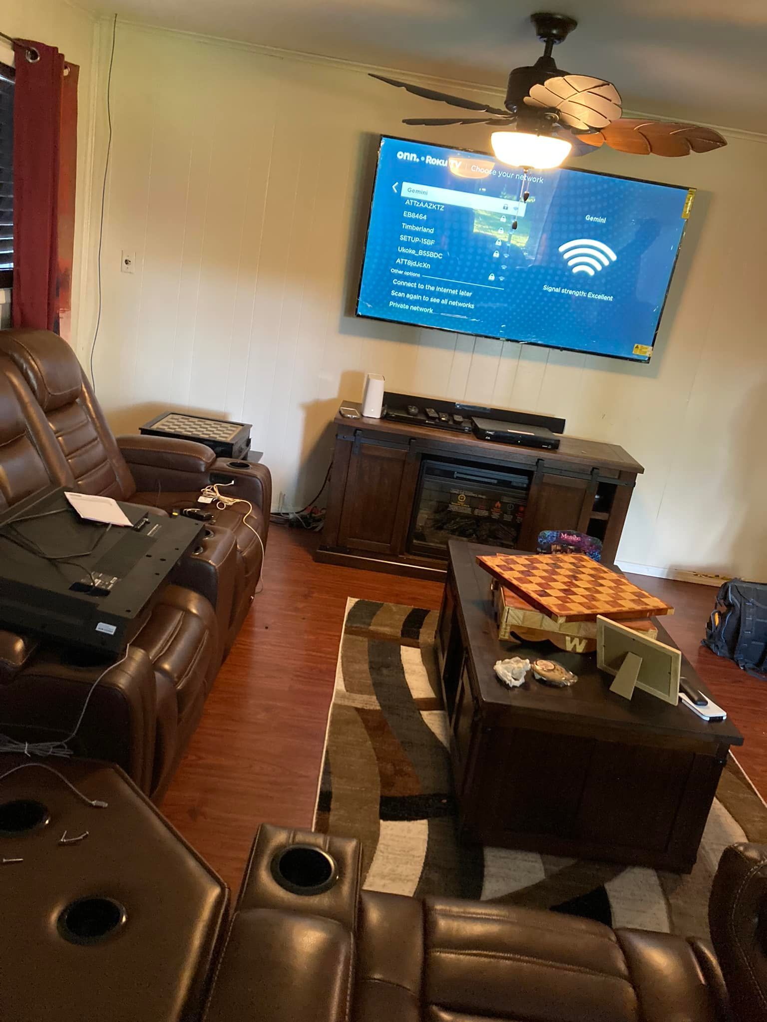 A living room with a large flat screen tv on the wall.