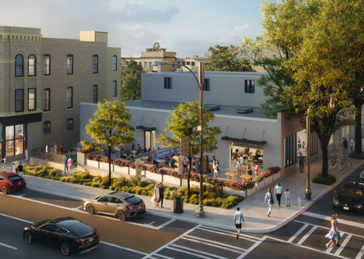 Corner café with outdoor seating on a sunny city street, pedestrians, trees, and parked cars at an intersection.