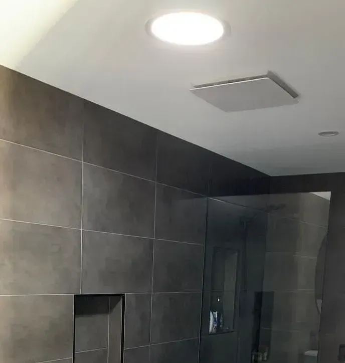 Bathroom With Gray Tiled Walls, Recessed Lighting, and a Glass Shower Door — Forster Solar and Lighting In Forster, NSW
