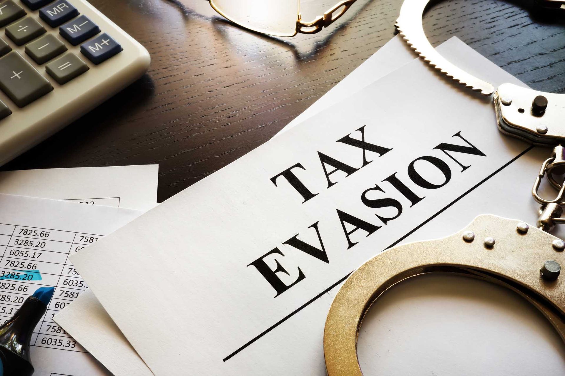 Tax evasion documents on desk — Lakeland, FL — Kaylor Law Group