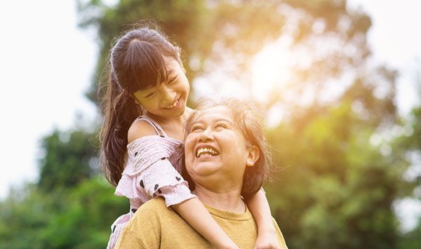 Third Party Special Needs Trust: A little girl is carrying an older woman on her back.