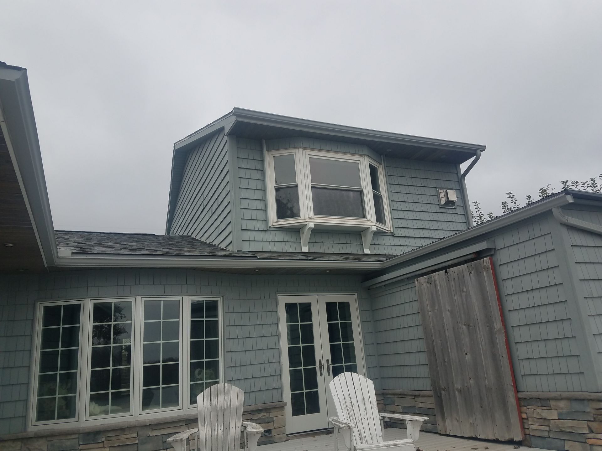 A house with a balcony and a lot of windows