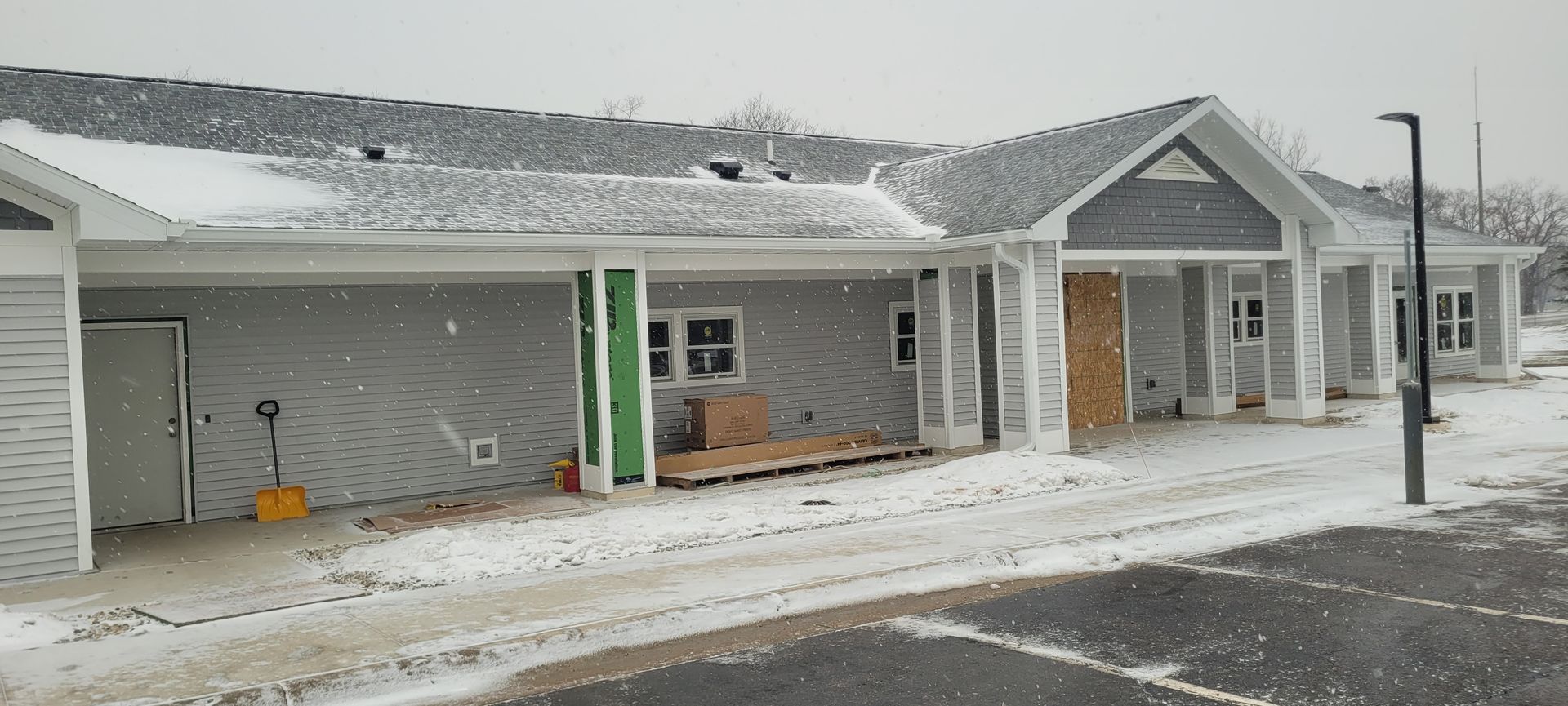 A building under construction is covered in snow.