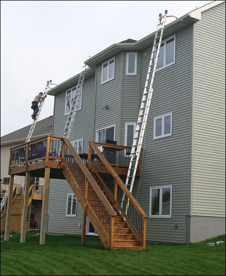 A white house with a porch and a roof.