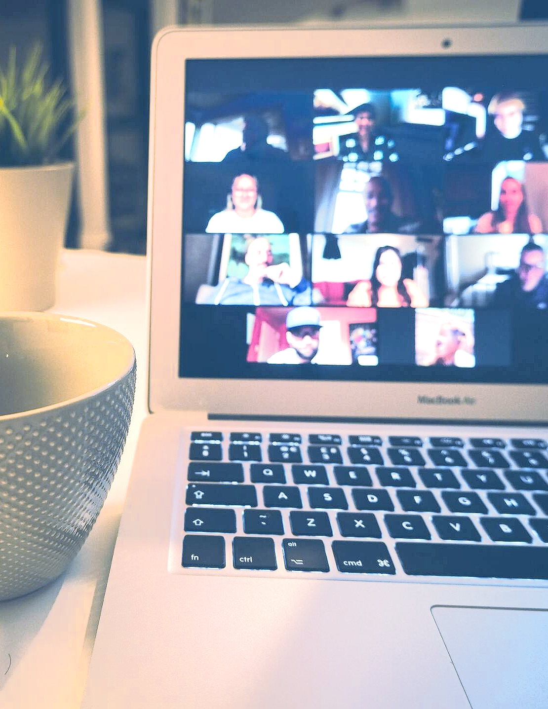 A laptop with a group of people on the screen